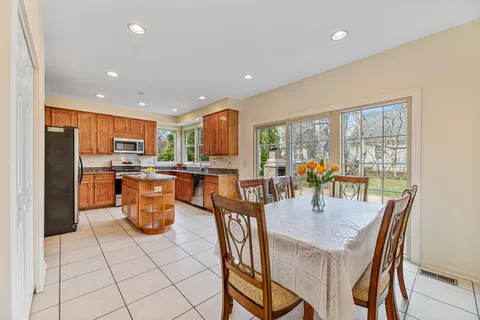a dining room with furniture a window and kitchen view