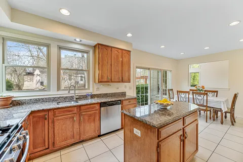 a kitchen with a stove sink and cabinets