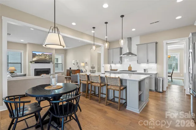 a large kitchen with a table and chairs