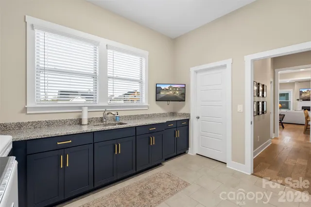 a bathroom with granite countertop a sink and a bathtub