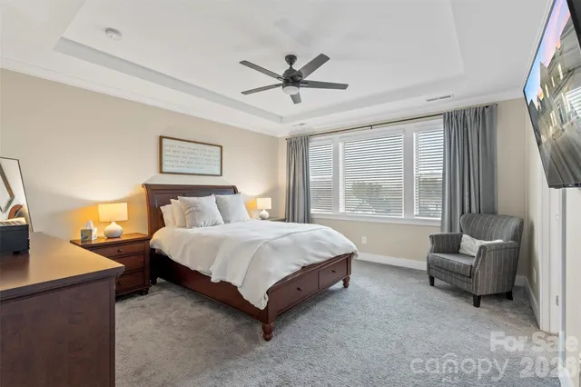 a spacious bedroom with a bed and a couch