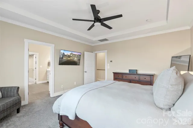 a bedroom with a large bed and a couch