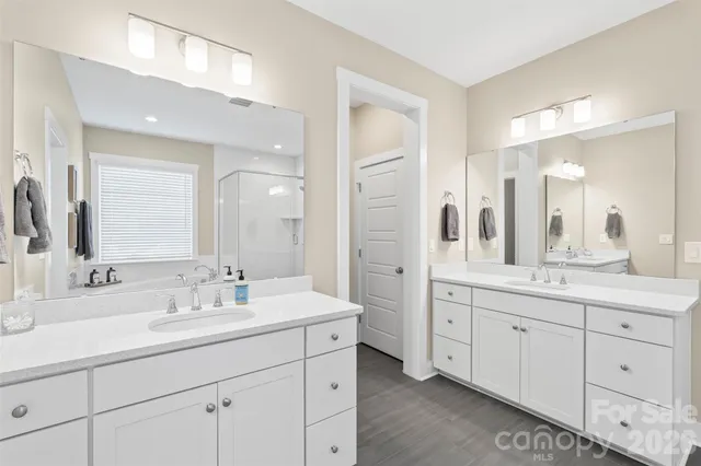 a bathroom with double sink and a mirror