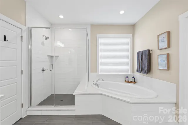 a bathroom with a tub sink and mirror
