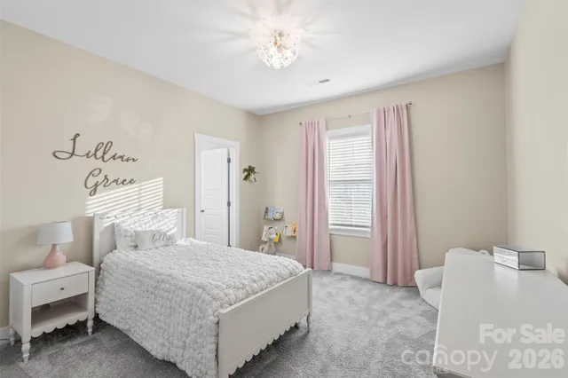 a bedroom with a bed and a table with chair