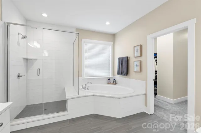 a bathroom with a shower sink and mirror