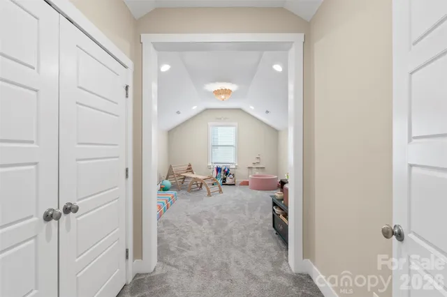 a view of a hallway with couch and closet