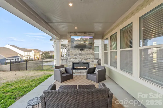 a view of a patio with couches chairs and a fire pit