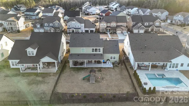 an aerial view of a house with a swimming pool