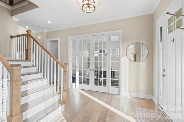 a view of entryway with wooden floor and front door