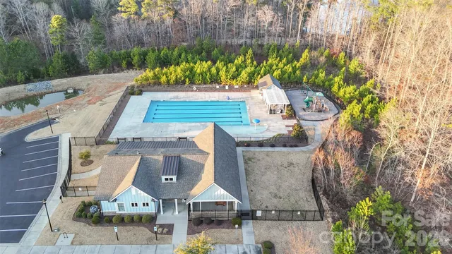 an aerial view of a house with a yard basket ball court and outdoor seating