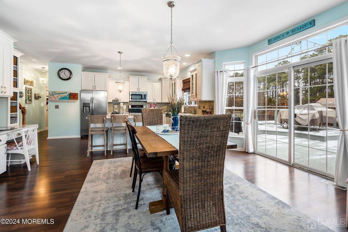 8 Williams Street Barnegat, NJ 08005 - Photo 19 of 64 a dining room with wooden floor a glass table and chairs