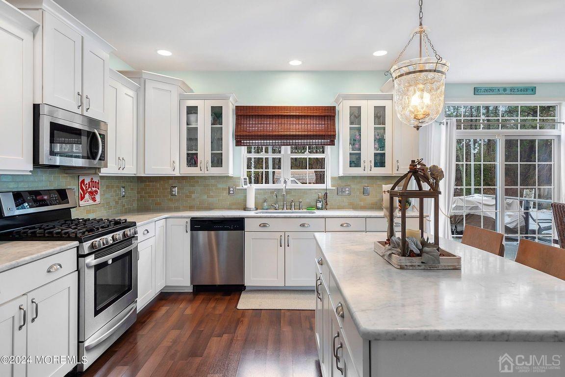8 Williams Street Barnegat, NJ 08005 - Photo 23 of 64 a kitchen with kitchen island granite countertop a stove top oven a sink a counter space wooden floor and cabinets