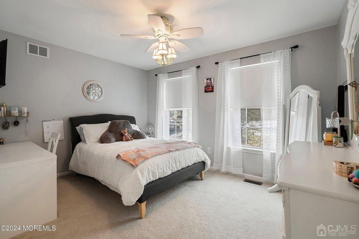 8 Williams Street Barnegat, NJ 08005 - Photo 32 of 64 a bedroom with a large bed and a chandelier