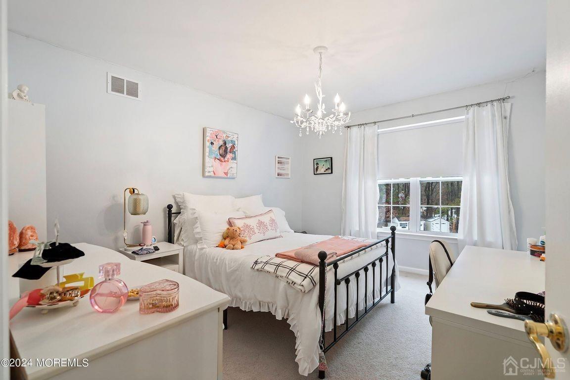 8 Williams Street Barnegat, NJ 08005 - Photo 36 of 64 a bedroom that has a bed and a table in it