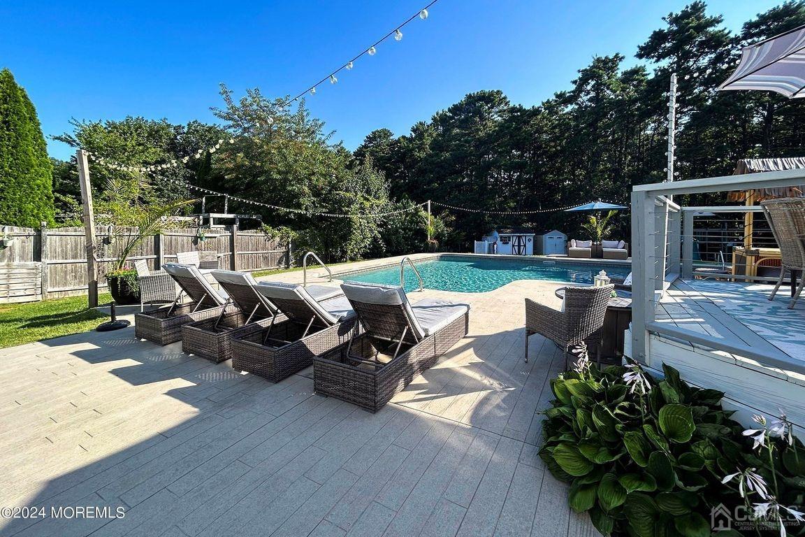 8 Williams Street Barnegat, NJ 08005 - Photo 50 of 64 a view of a patio with table and chairs with wooden floor and fence