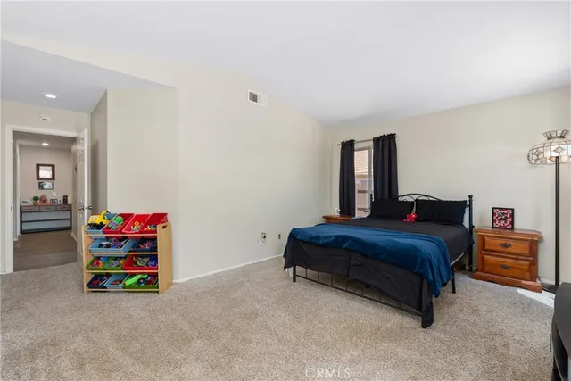 a bedroom with a bed and cabinets