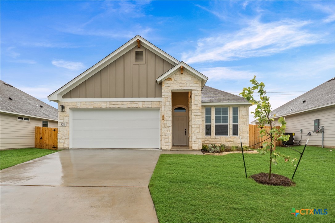 a front view of house with a garden