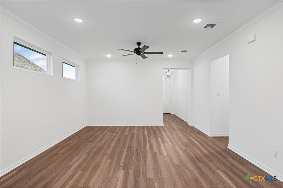 8011 Pineridge Way Temple, TX 76502 - Photo 14 of 32 a view of empty room with wooden floor