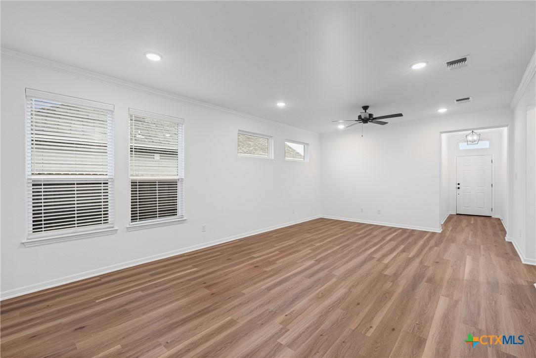 8011 Pineridge Way Temple, TX 76502 - Photo 15 of 32 a view of empty room with wooden floor and windows