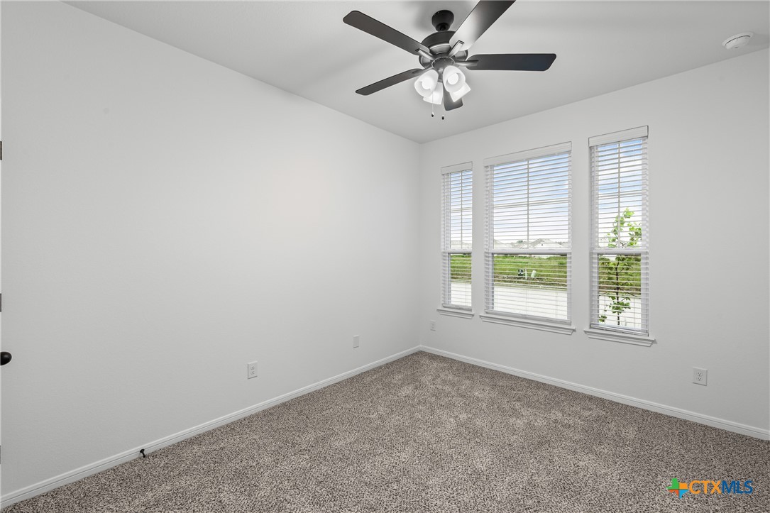 8011 Pineridge Way Temple, TX 76502 - Photo 16 of 32 an empty room with a window and a fan