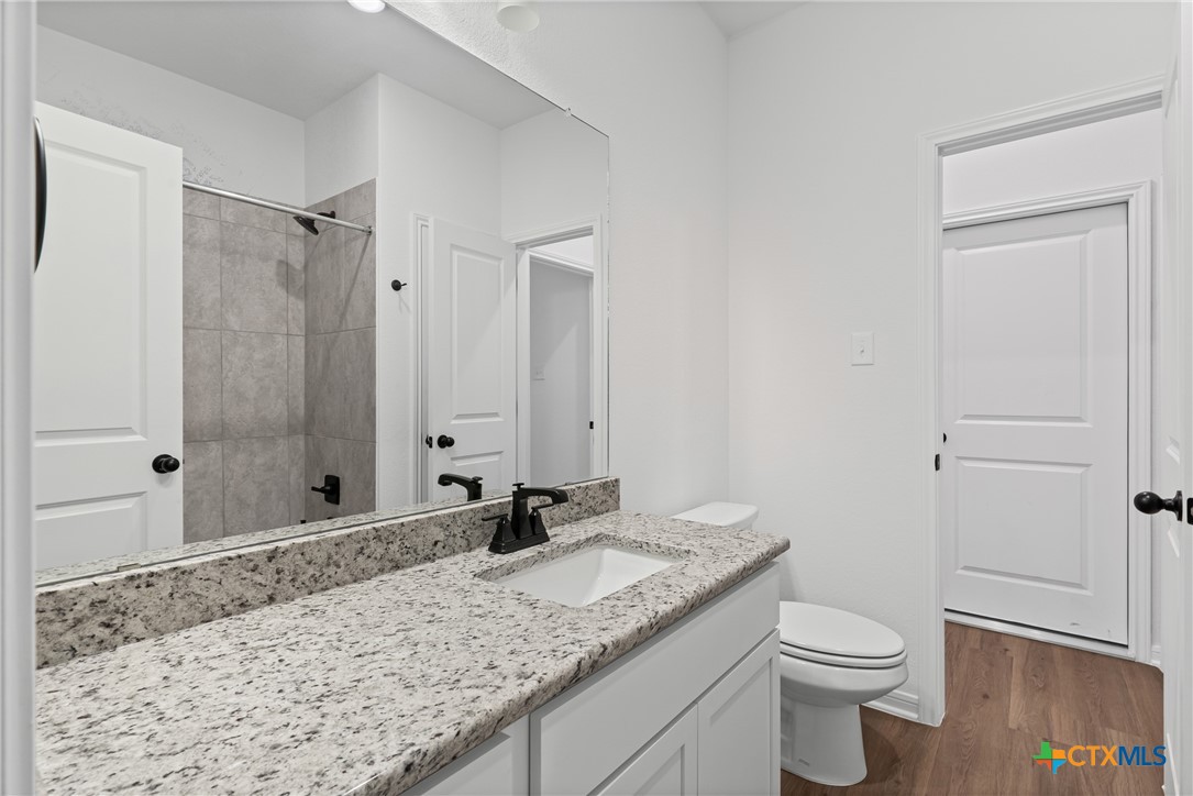 8011 Pineridge Way Temple, TX 76502 - Photo 20 of 32 a bathroom with a granite countertop sink toilet and shower