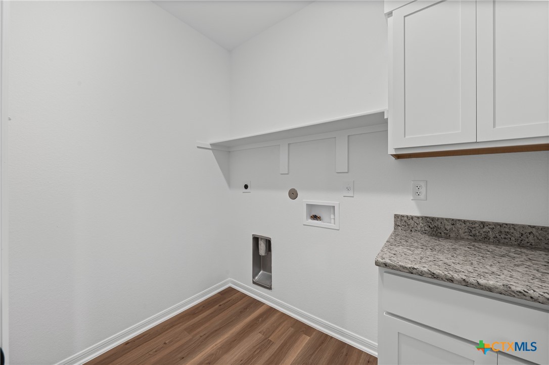 8011 Pineridge Way Temple, TX 76502 - Photo 24 of 32 a kitchen with granite countertop white cabinets and a sink