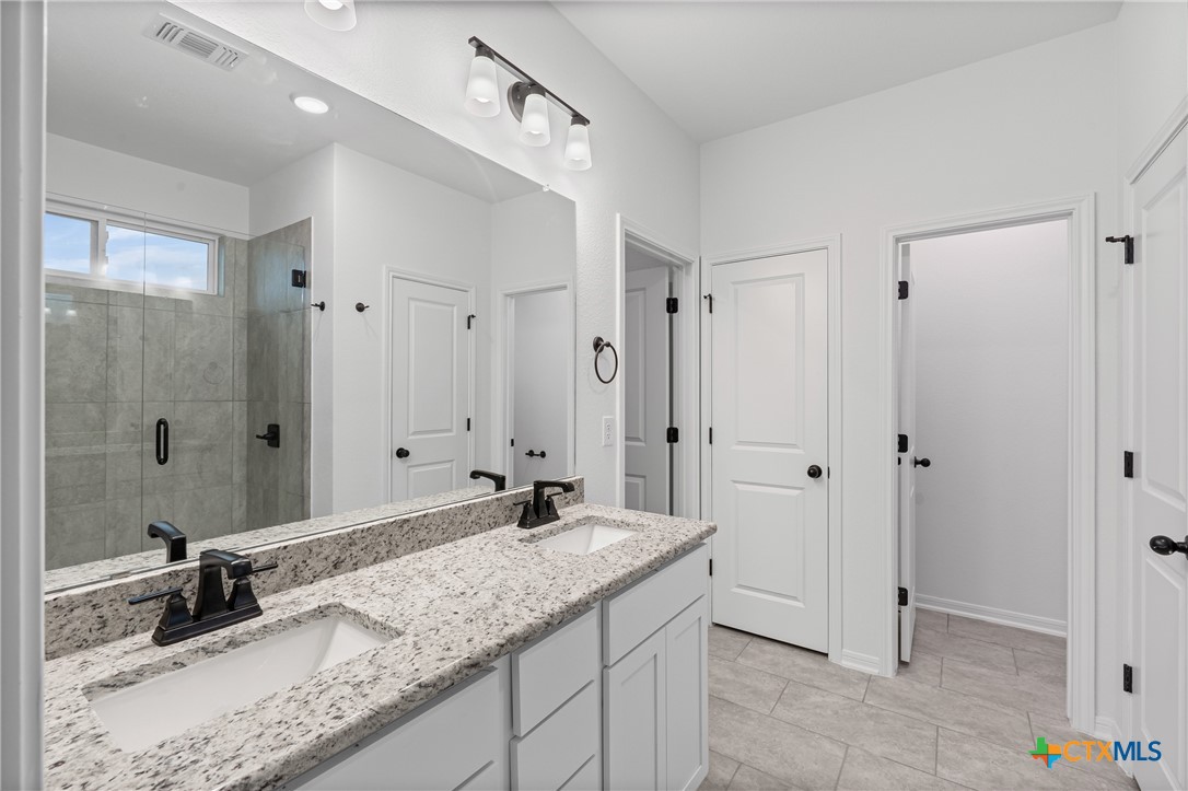 8011 Pineridge Way Temple, TX 76502 - Photo 28 of 32 a bathroom with a granite countertop sink mirror and double