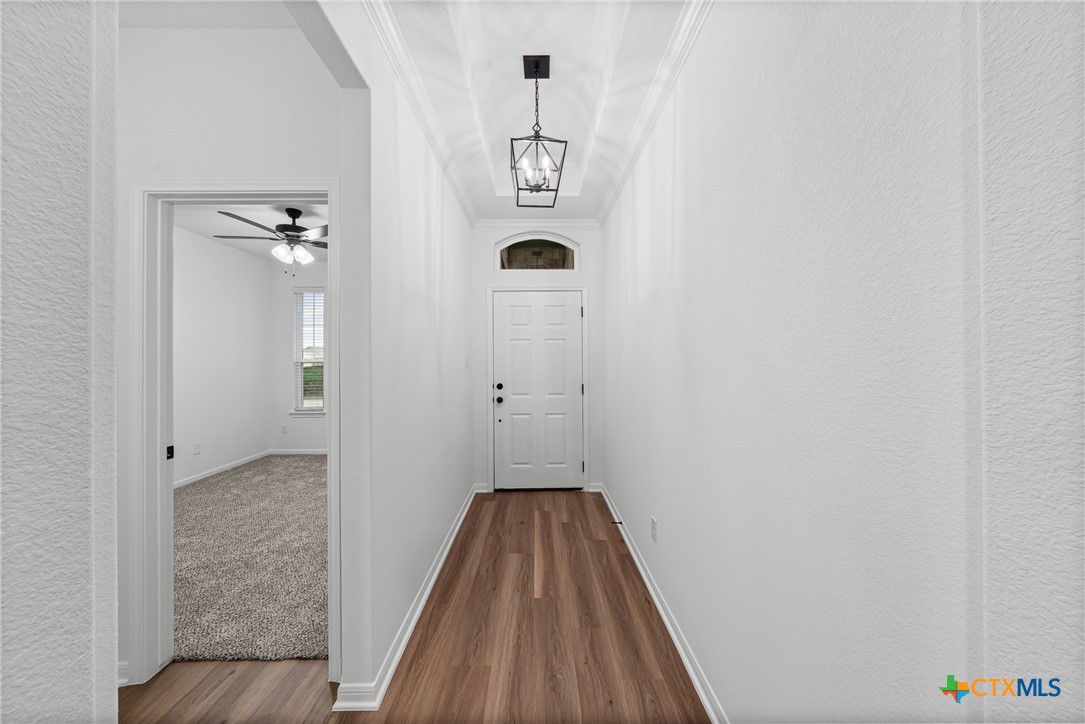 8011 Pineridge Way Temple, TX 76502 - Photo 6 of 32 a view of a hallway with wooden floor