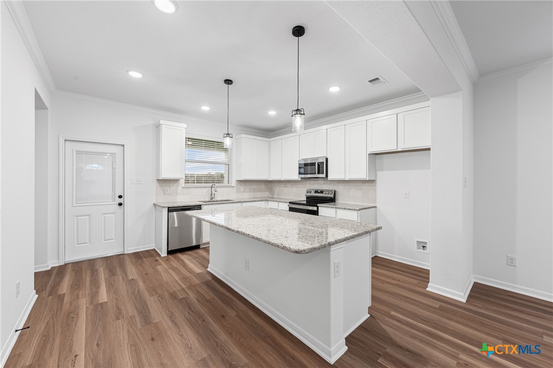 8011 Pineridge Way Temple, TX 76502 - Photo 7 of 32 a kitchen with a sink a center island stainless steel appliances and cabinets