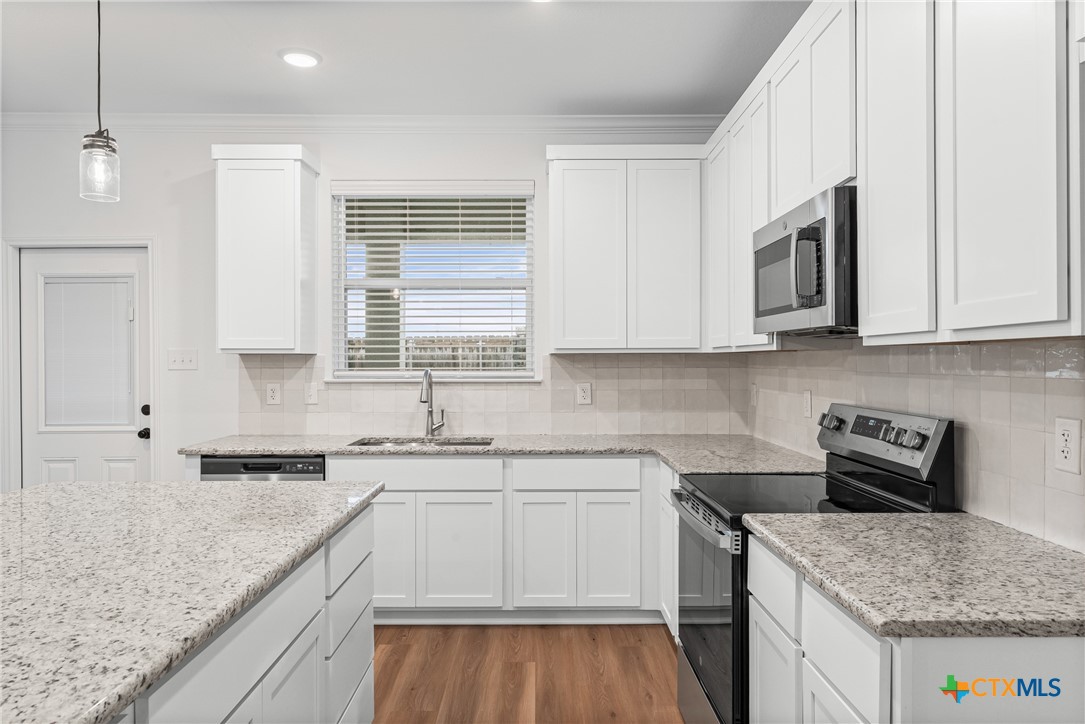 8011 Pineridge Way Temple, TX 76502 - Photo 10 of 32 a kitchen with stainless steel appliances granite countertop a sink stove and microwave