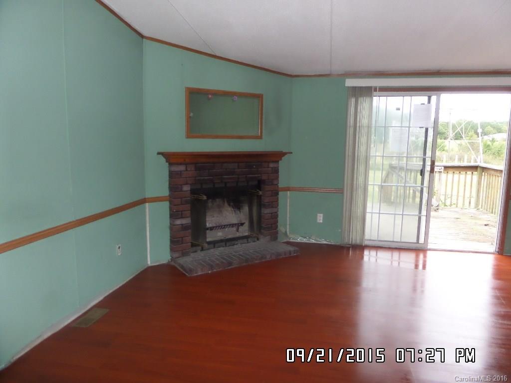 8480 Smith Road Kannapolis, NC 28081 - Photo 6 of 11 a view of an empty room with a fireplace