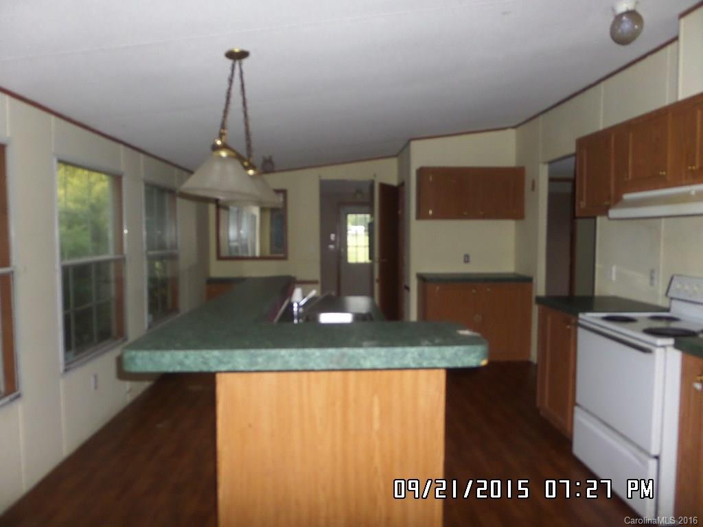 8480 Smith Road Kannapolis, NC 28081 - Photo 8 of 11 a view of a kitchen with kitchen island a counter top space and wooden floor