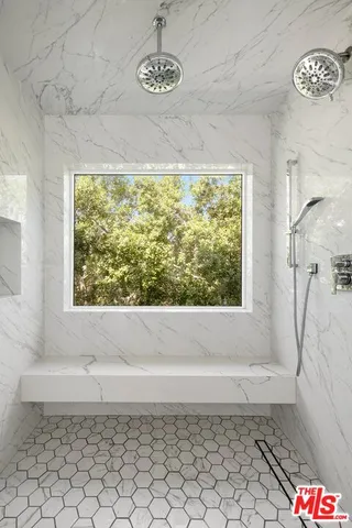 a bathroom with a bathtub and a shower