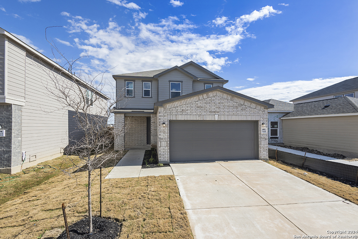 a front view of a house with yard