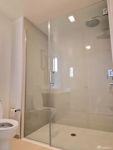 a bathroom with a shower a toilet and sink