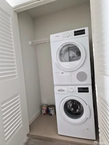 a large white kitchen with stainless steel appliances