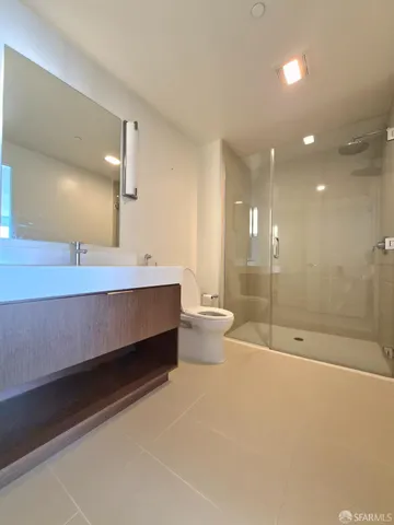 a bathroom with a double vanity sink toilet and shower