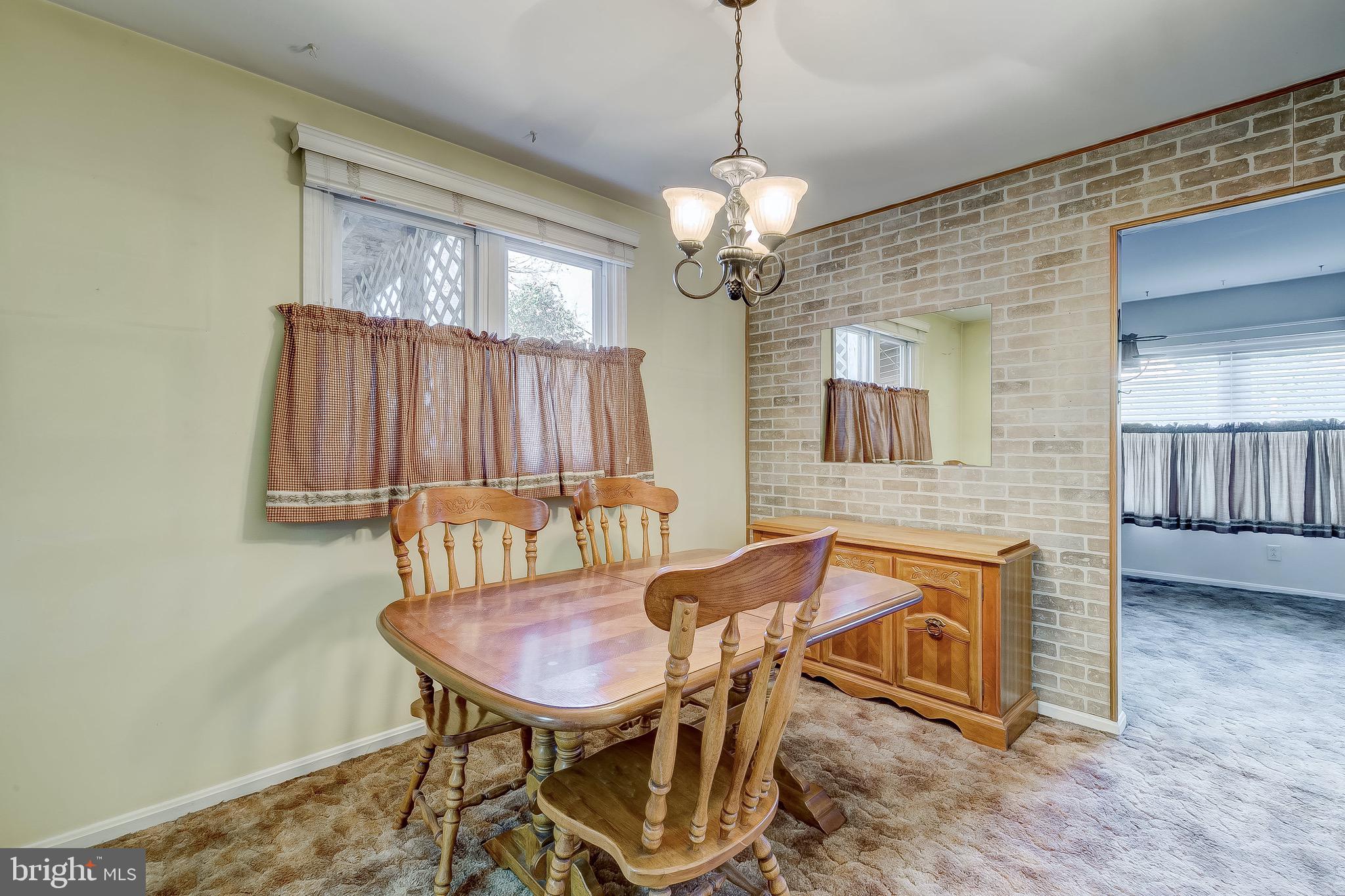 9326 Perglen Road Baltimore, MD 21236 - Photo 23 of 55 a view of a dining room with furniture and a chandelier
