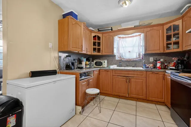 a kitchen with a sink a stove and cabinets