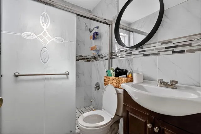 a bathroom with a sink toilet and a mirror