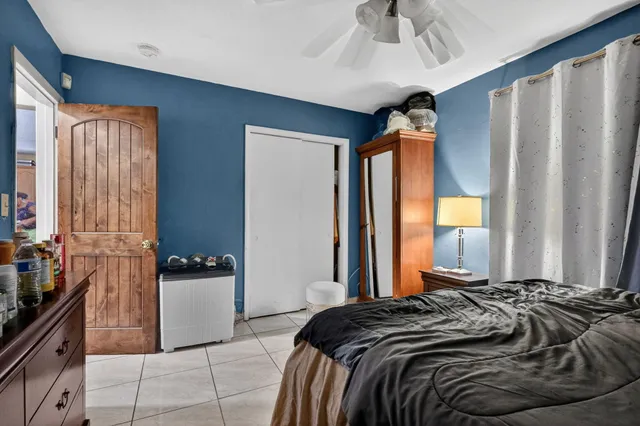 a bedroom with a bed and a dresser