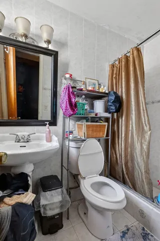a bathroom with a sink toilet and mirror