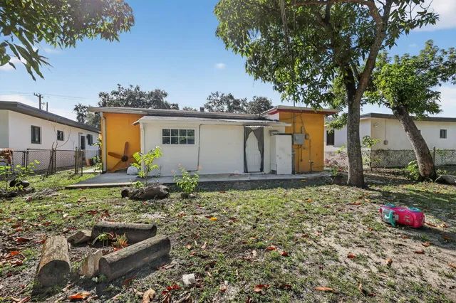 a backyard of a house with barbeque oven