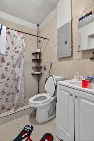 a bathroom with a toilet sink and shower curtain