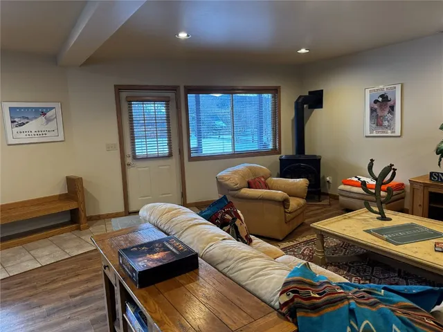 a living room with furniture a rug and a window