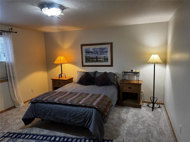 a bed room with a bed and a lamp