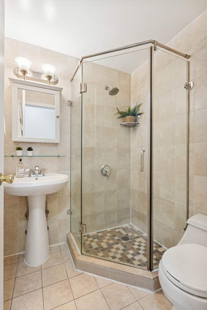 27-16 41st Avenue, Unit 3D Queens, NY 11101 - Photo 10 of 14 a bathroom with a sink toilet and shower