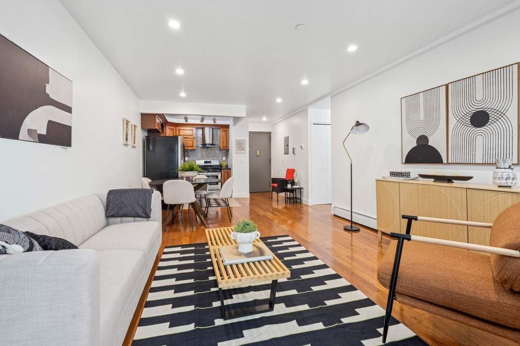 27-16 41st Avenue, Unit 3D Queens, NY 11101 - Photo 4 of 14 a living room with furniture a rug and white walls