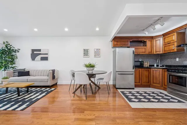 a living room with furniture a rug and white walls